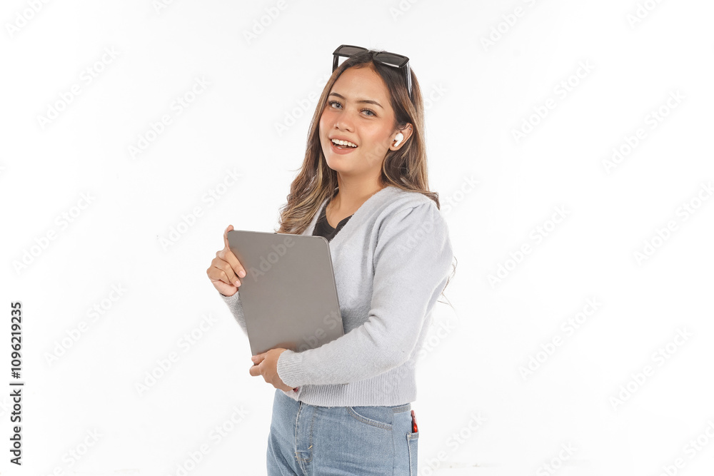 Young Asian woman smiling wearing airpods and glasses holding tablet while looking at camera Young Asian woman smiling wearing airpods and glasses holding tablet while looking at camera