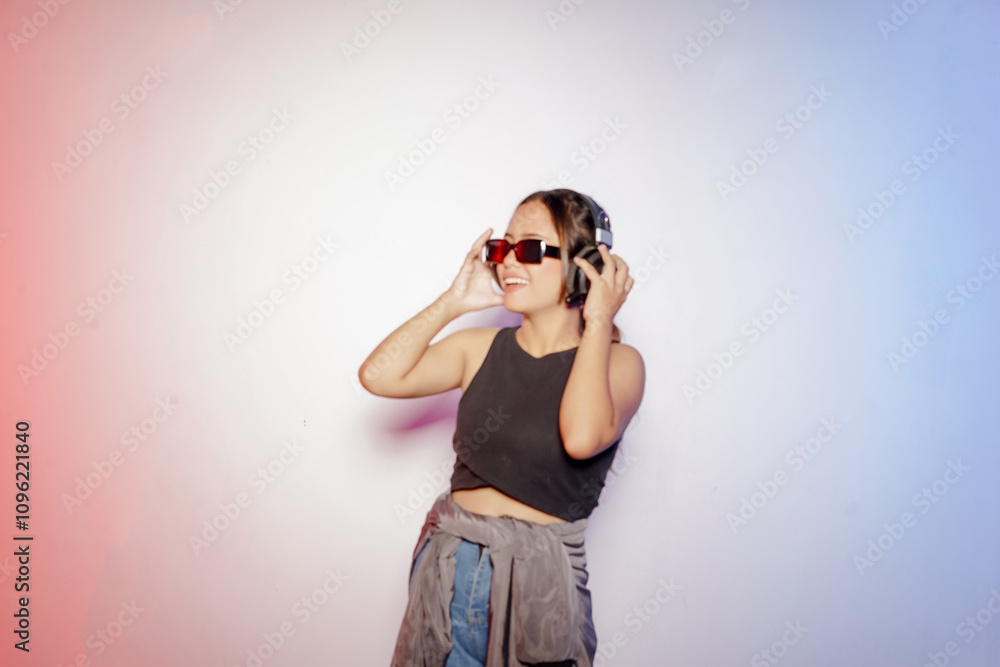 cheerful young asian dancer woman wearing headphones and glasses listening to music cheerful young asian dancer woman wearing headphones and glasses listening to music