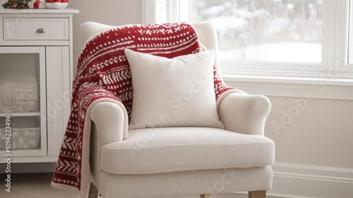 Nursery chair draped with a Christmasthemed blanket and a festive reindeer pillow for extra holiday cheer   nursery chair, holiday comfort photo