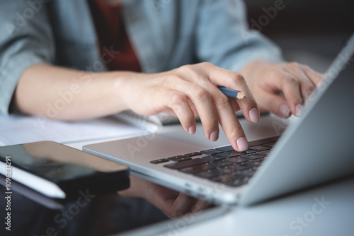 Close up, woman hand typing on laptop computer keyboard. Business woman online working on laptop computer, surfing the internet, searching the information at home office, e-learning