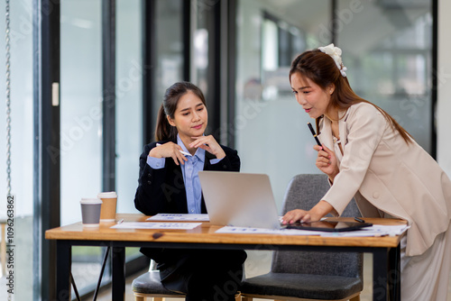 Two asian business women Accounting using calculating income-expenditure and analyzing real estate investment documents data report Financial and tax systems concept.