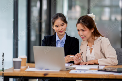 Two asian business women Accounting using calculating income-expenditure and analyzing real estate investment documents data report Financial and tax systems concept.