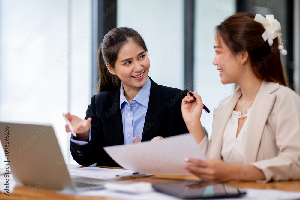 Two asian business women Accounting using calculating income-expenditure and analyzing real estate investment documents data report Financial and tax systems concept. Two asian business women Accounting using calculating income-expenditure and analyzing real estate investment documents data report Financial and tax systems concept.