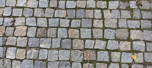 the surface is paved with cobblestones, square stones