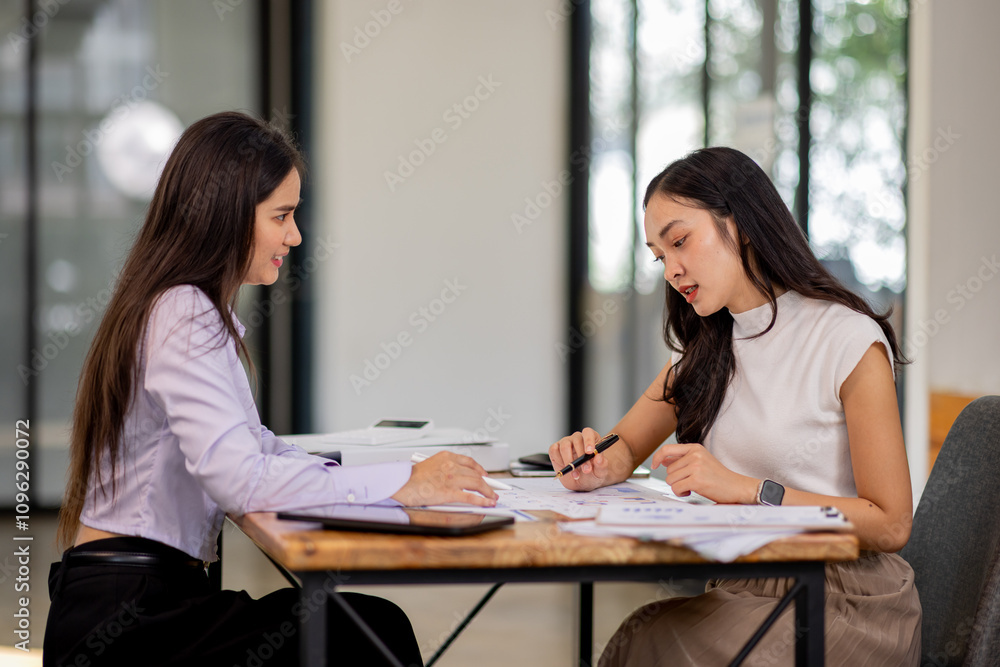 Financial Business two women analyze the graph of the company's performance to create profits and growth, Market research reports and income statistics, Financial and Accounting concept. Financial Business two women analyze the graph of the company's performance to create profits and growth, Market research reports and income statistics, Financial and Accounting concept.
