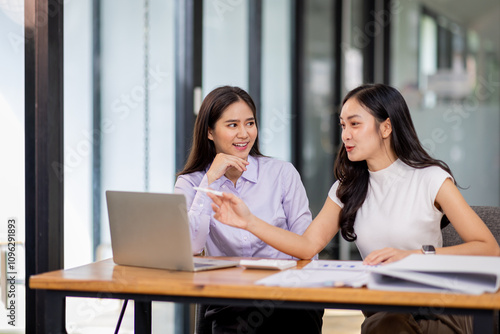 Financial Business two women analyze the graph of the company's performance to create profits and growth, Market research reports and income statistics, Financial and Accounting concept. 