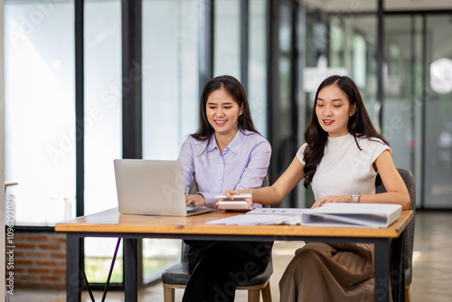 Financial Business two women analyze the graph of the company's performance to create profits and growth, Market research reports and income statistics, Financial and Accounting concept. 