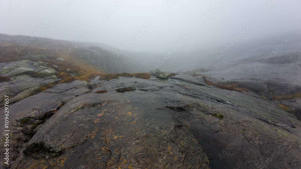 Foggy Mountain Landscape with Rocky Terrain