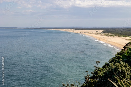 Scenic coastal view of a sandy beach meeting the ocean.