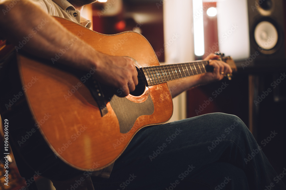 Obraz premium Acoustic guitar recording session in a studio atmosphere. Close-up.
