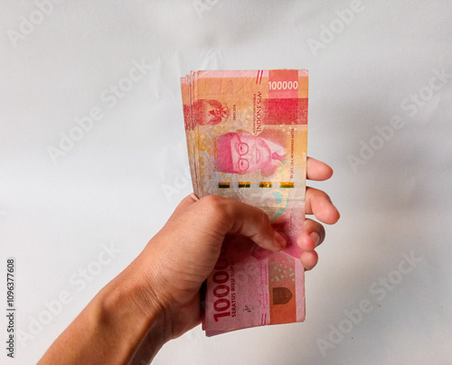 Cash payment concept. Indonesian rupiah currency (Rp. 100.000 Seratus Ribu Rupiah), One hundred thousand Indonesian rupiah money. photo