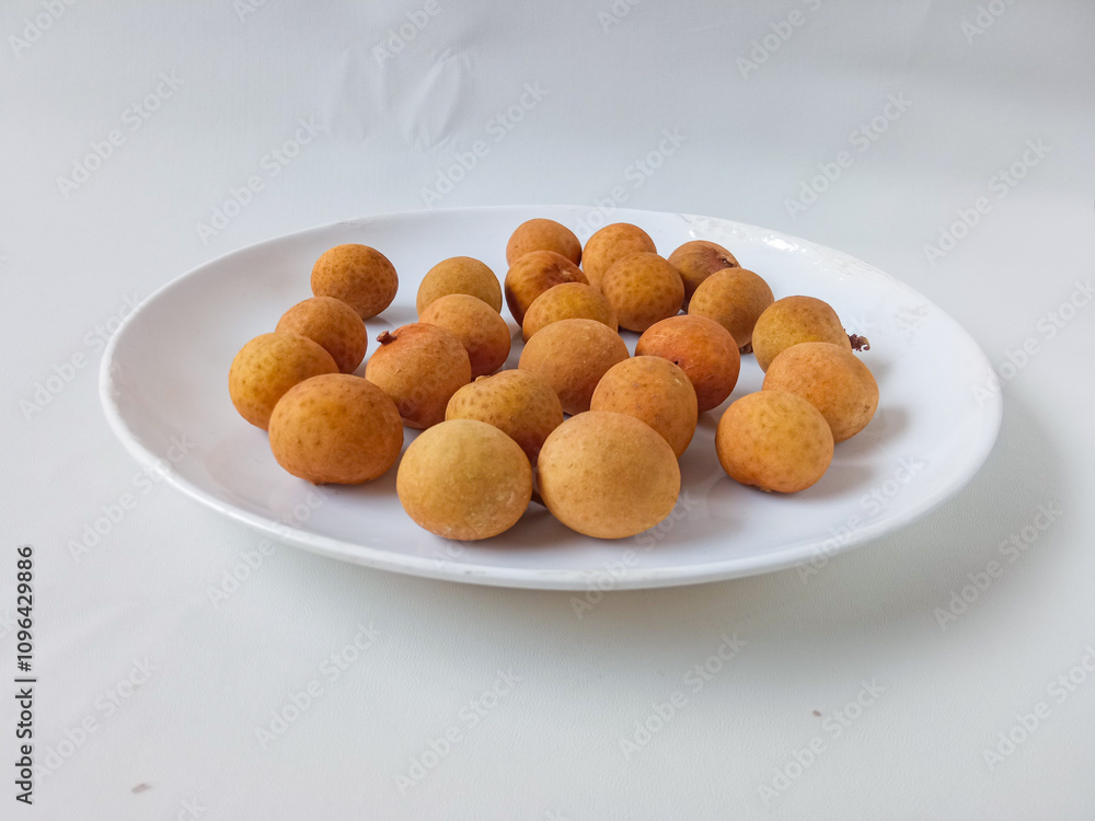 longan fruit on a white round plate isolate on white background longan fruit on a white round plate isolate on white background
