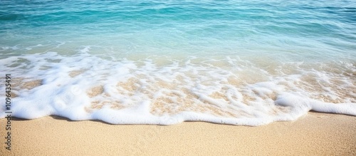 blue ocean waves gently lapping on sandy shore creating a serene beach texture backdrop for relaxation and vacation themes photo