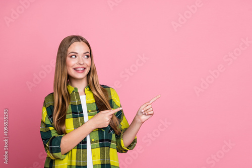 Photo portrait of lovely young lady look point empty space dressed yellow plaid clothes isolated on pink color background