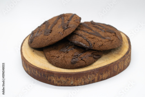 Chocolate chip cookies on wood slice with white background