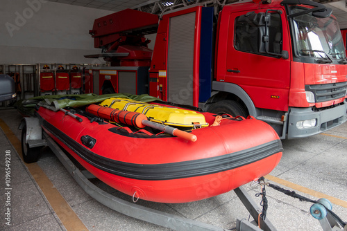 Fire boats and fire trucks are parked in the garage photo