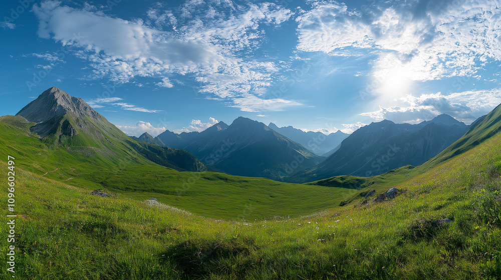Obraz premium Beautiful green meadow with mountains in the background, a sunny day panorama. Panoramic landscape of the Alps mountain range in the summertime 