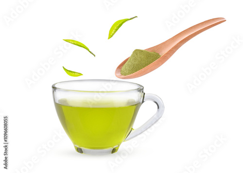 Refreshing green tea in cup, woodden spoon and leaves on transparent. photo