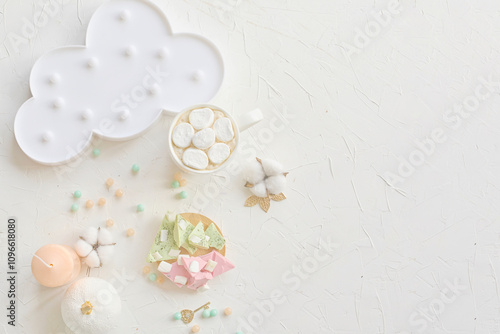 Charming pastel-colored dessert setup featuring marshmallows, a cloud plate, and decor on a white background.