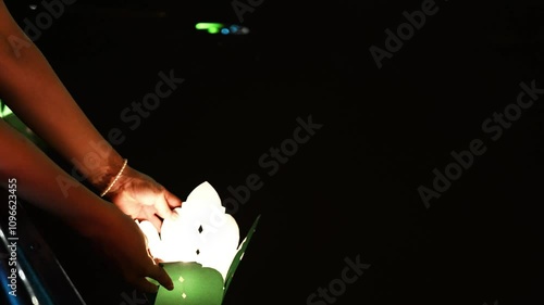 Hands Releasing Lanterns in Hoi An, Vietnam