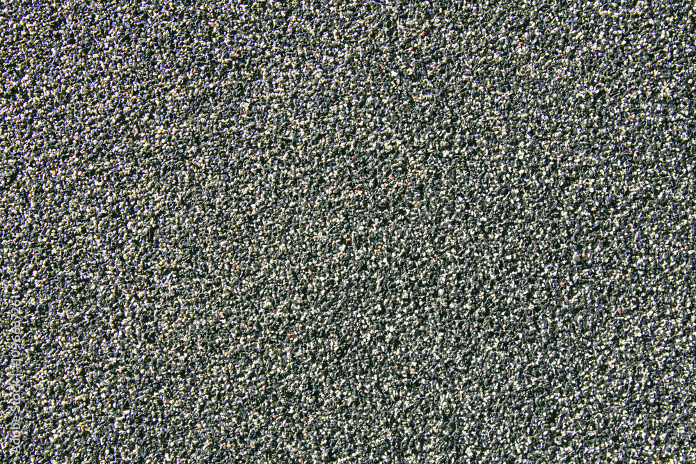 Dark wall surface, backdrop. Decorative plaster with mosaic pattern. Black and white grainy decorated surface. Mosaic, granulated textured coating. Two-component coating made of small crushed stones Dark wall surface, backdrop. Decorative plaster with mosaic pattern. Black and white grainy decorated surface. Mosaic, granulated textured coating. Two-component coating made of small crushed stones