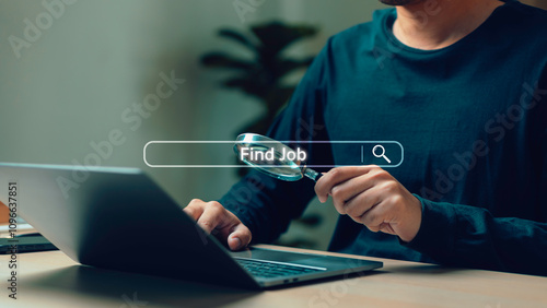 Obraz na płótnie A person using a laptop while holding a magnifying glass, symbolizing online job search and digital recruitment concepts in a modern workplace setting. explore career opportunities in a competitive. w salonie