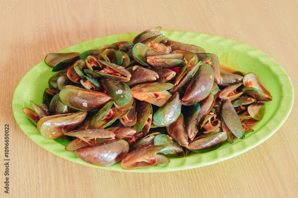 A seafood dish made from clams with sweet and sour sauce, menu in a seafood restaurant. A seafood dish made from clams with sweet and sour sauce, menu in a seafood restaurant.