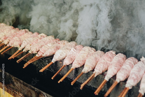 Grilling goat skewer or sate buntal kambing, an authentic Indonesian food. photo