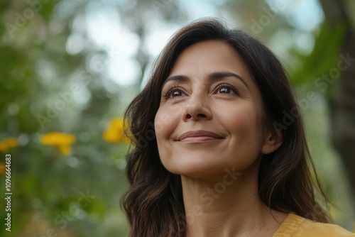 Middle age hispanic woman smiling confident looking to the sky at park