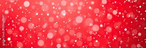 A gentle flurry of small snowflakes settles on a bright red gradient background in a magical and festive winter environment, flurries, snowy