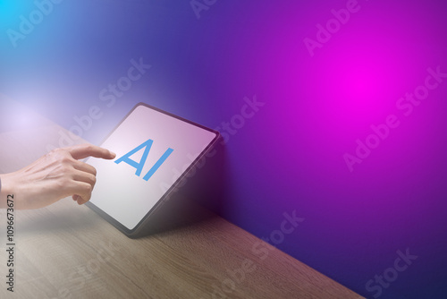 Hand Touching Tablet Displaying AI on Colorful Background photo