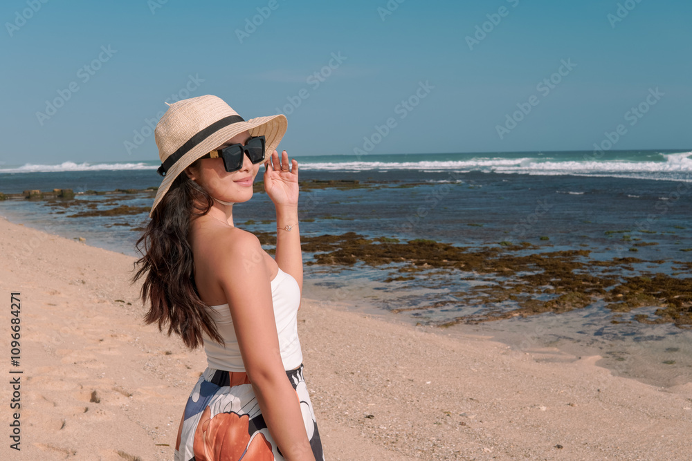 Beautiful Asian woman standing by the Drini beach, Yogyakarta, enjoying holiday and traveling. Beautiful Asian woman standing by the Drini beach, Yogyakarta, enjoying holiday and traveling.