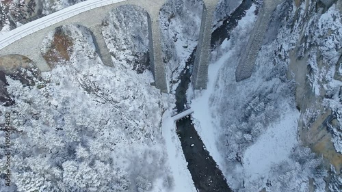 Snowy landscape at Filisur Albula with famous Landwasser Viaduct in the Swiss Alps on a snowy autumn day. Movie shot November 22nd, 2024, Filisur Albula, Switzerland.