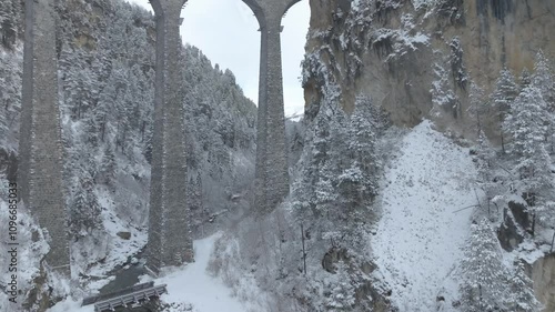 Snowy landscape at Filisur Albula with famous Landwasser Viaduct in the Swiss Alps on a snowy autumn day. Movie shot November 22nd, 2024, Filisur Albula, Switzerland.