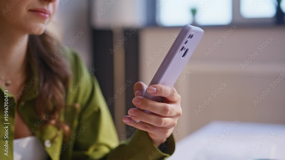 Girl finger pointing smartphone screen turning on application at home closeup. Girl finger pointing smartphone screen turning on application at home closeup.