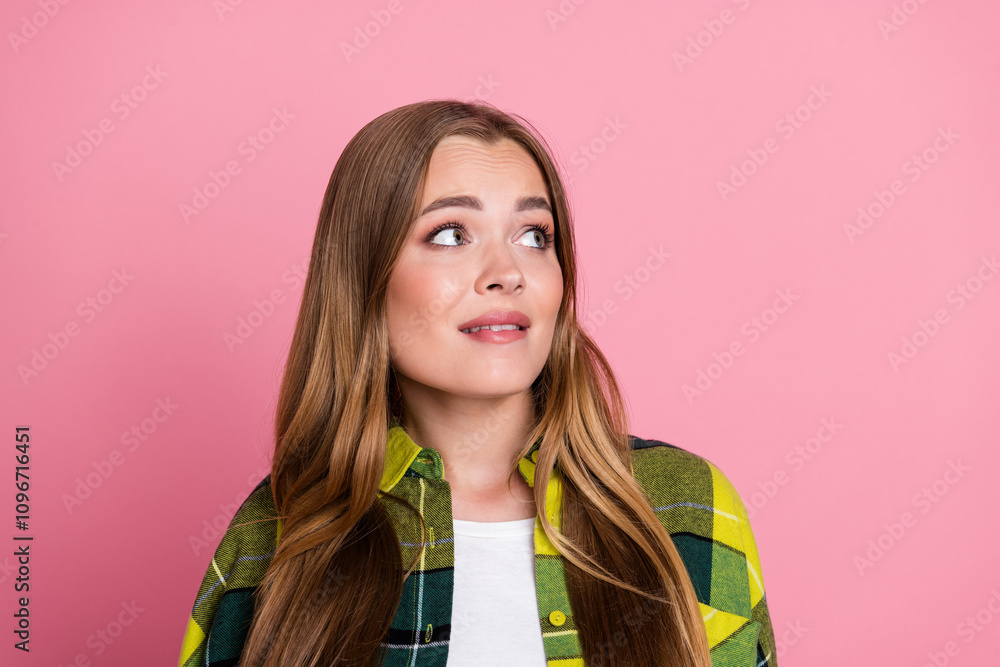 Photo portrait of lovely young lady look nervous empty space dressed yellow plaid clothes isolated on pink color background Photo portrait of lovely young lady look nervous empty space dressed yellow plaid clothes isolated on pink color background
