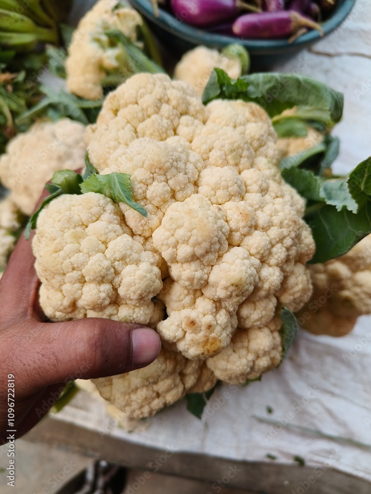 A customer purchasing fresh Cauliflower A customer purchasing fresh Cauliflower