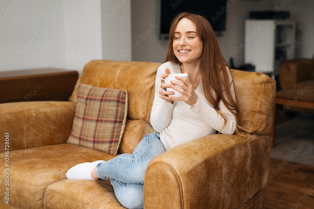 Cozy afternoon relaxing on a sofa while enjoying a warm drink at home Cozy afternoon relaxing on a sofa while enjoying a warm drink at home