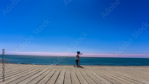 Photography Lake Ontario beach, Toronto, Canada - Small boy with his scooter on the boardwal