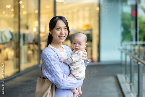 Mother going out with her baby outside photo