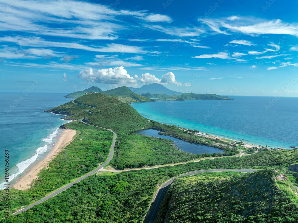 Aerial view of St Kitts shores with turquoise water Nevis peak in the background
