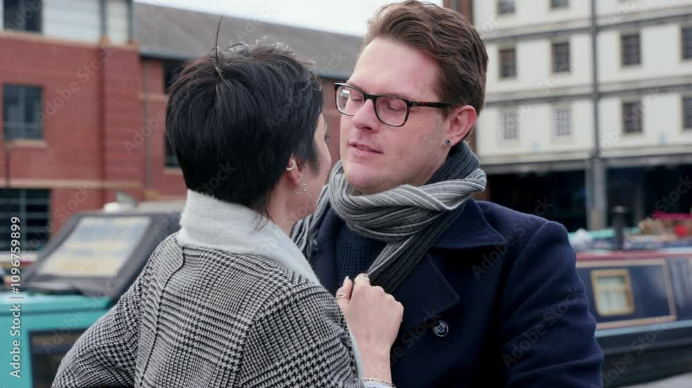 Couple shares a heartfelt moment by the canal in a charming urban setting Couple shares a heartfelt moment by the canal in a charming urban setting