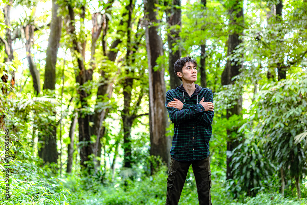 Man walking alone in deep forest and feel anxiety. Man feel nervously to walking alone in the forest Man walking alone in deep forest and feel anxiety. Man feel nervously to walking alone in the forest