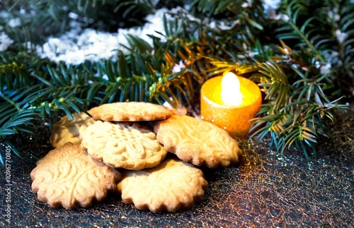 Christmas butter cookies burning candle and pine needles