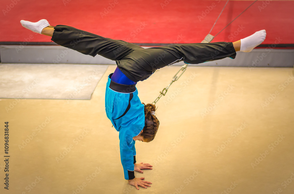 Photo & Art Print Young gymnast girl practicing handstand, samards