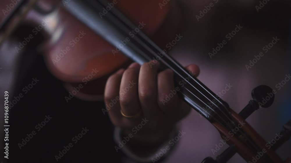 Close up Cinematic Musician playing violin focus on hand with blurry background Close up Cinematic Musician playing violin focus on hand with blurry background
