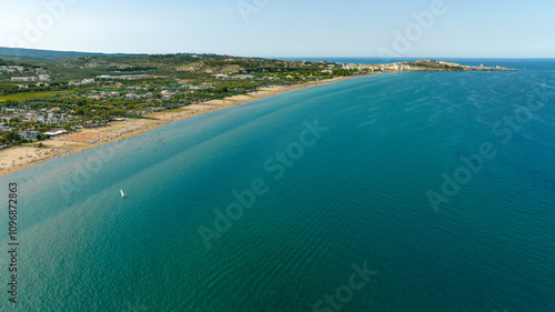 Aerial view of the long beach of Vieste, a tourist destination of Gargano, in the province of Foggia, Puglia, Italy. In the background is the historic center of the city. photo