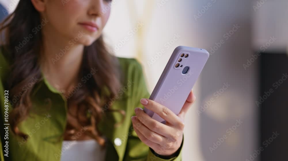Positive brunette scrolling smartphone choosing online purchases at home closeup Positive brunette scrolling smartphone choosing online purchases at home closeup
