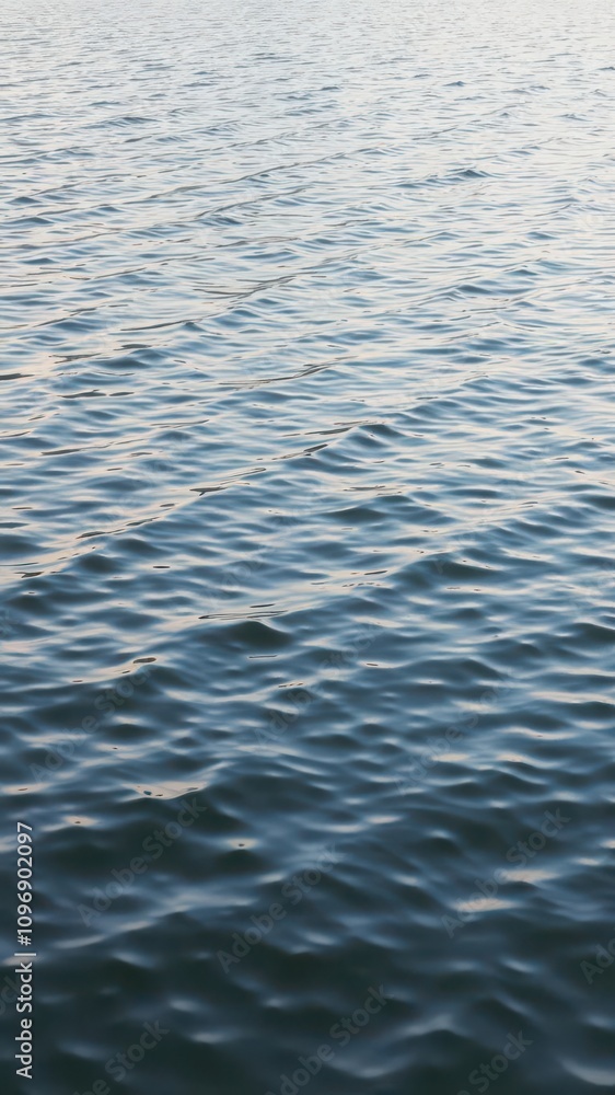 Rippling waves on a serene lake reflecting the sky, nature Rippling waves on a serene lake reflecting the sky, nature