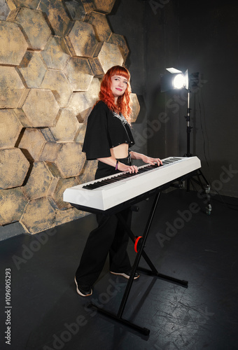 Beautiful red-haired keyboardist woman performing confidently